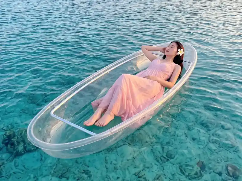 Enjoying a transparent kayak ride through crystal clear waters with Sisipan Island Resort near Semporna